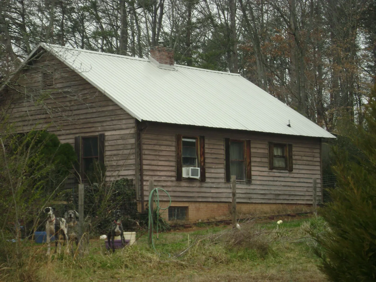 White metal roof on an old wood sided farmhouse, from a Metal Roof Installation job in Vacherie